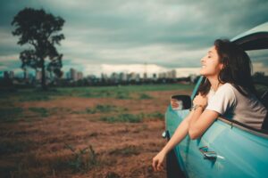 : Woman journaling in nature during her life trip 